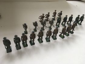 A collection of 23 metal toy soldiers by Britains