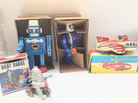 A Collection of 4 Boxed Chinese tinplate Toys. A Baby Robot. A Space Man and a Rocket Racer. NO