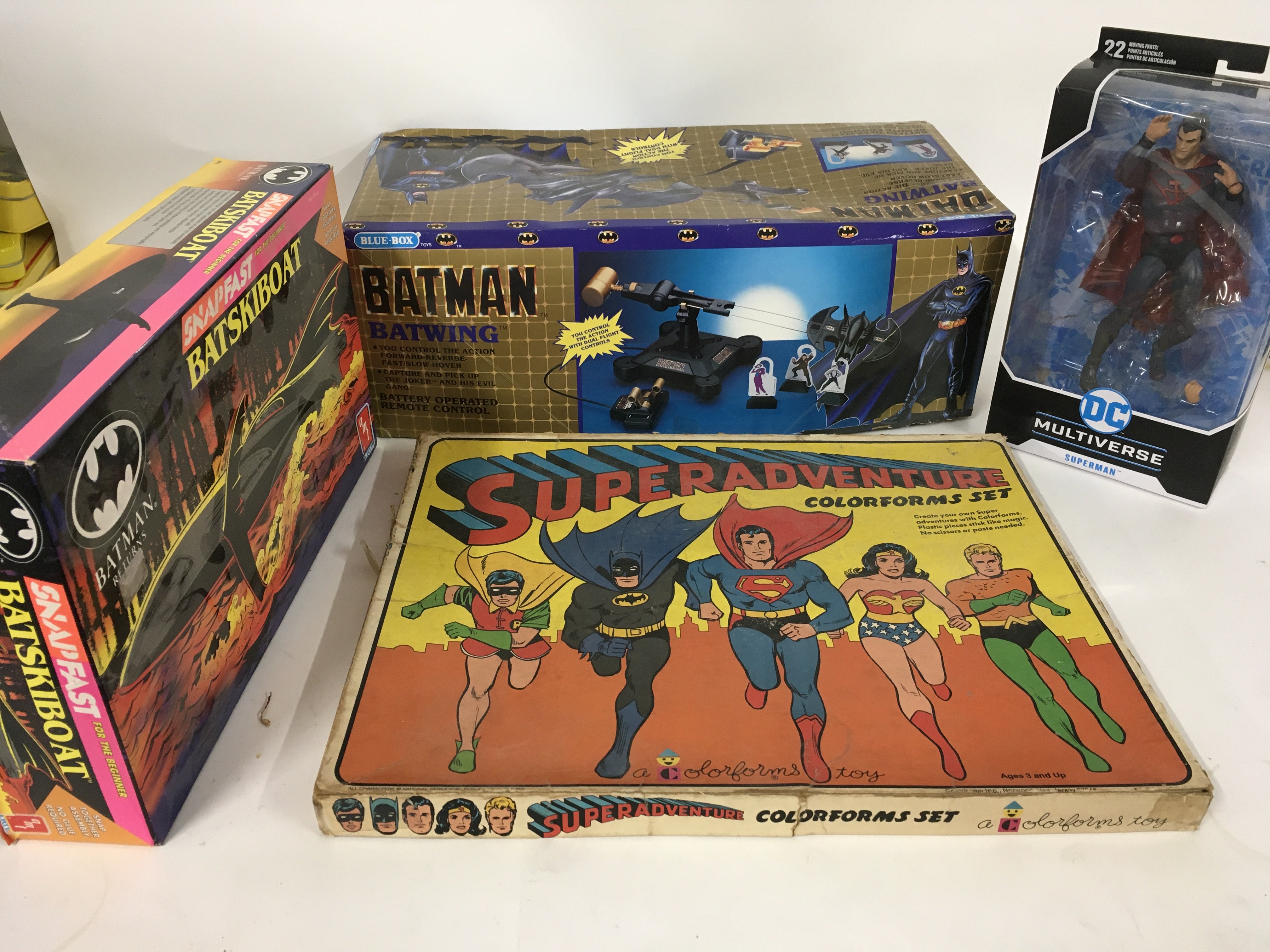 A collection of 4 superhero toys . Super adventure
