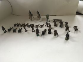 A collection of metal soldiers in various poses in