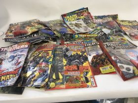 A collection of transformers comics in excess of 30 issues mainly still unopened and with free toy s