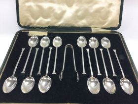 A cased set of twelve silver tea spoons and sugar