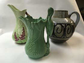 A ports pottery jug along with a Carltonware jug and a slyvac Matt green 1960 stork jug.