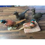 A collection of various pheasant figurines