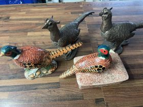 A collection of various pheasant figurines