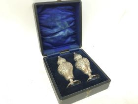 A cased Silver Hallmarked cruet set, decorated wit