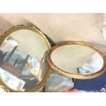 Two large circular mirrors with patterned metal fr