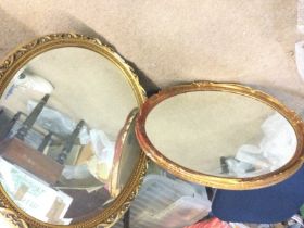 Two large circular mirrors with patterned metal fr