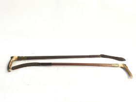 Two Vintage riding crops with horn handles one wit