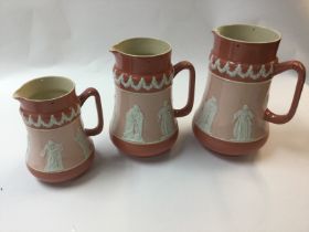A collection of three graduated Carltonware jugs decorated with neo classical figures and one