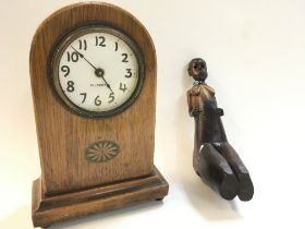A tribal carved pipe body in the female form and a Gilbert mantle clock, dimensions 8x15x22cm