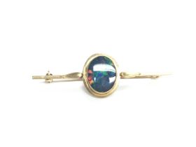 A 9ct gold bar brooch set with opal. 3.64g