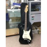 A Fender Squier Stratocaster electric guitar with gigging bag and spare strings. Shipping category