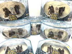 A collection of boxed lord of the rings figures.