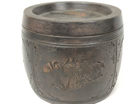 A Chinese terracotta tea caddy, engraved with flor