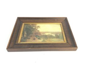 Framed oil painting depicting a scenic view of a w