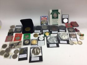 A collection of assorted coins and commemorative m