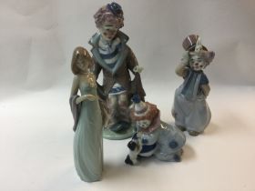 A collection of three lladro clowns and one lladro lady figure.