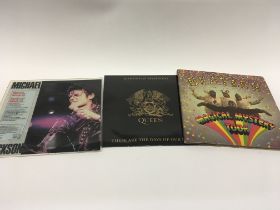Three records including Queen, the Beatles and Mic