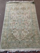 A pale green ground part silk rug 190cm x 123cm