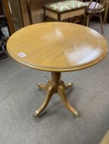 A small walnut circular occasional table with bras