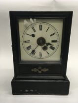 A French 8 day wood cased clock with key.