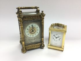 An ornate brass framed carriage clock with enamel