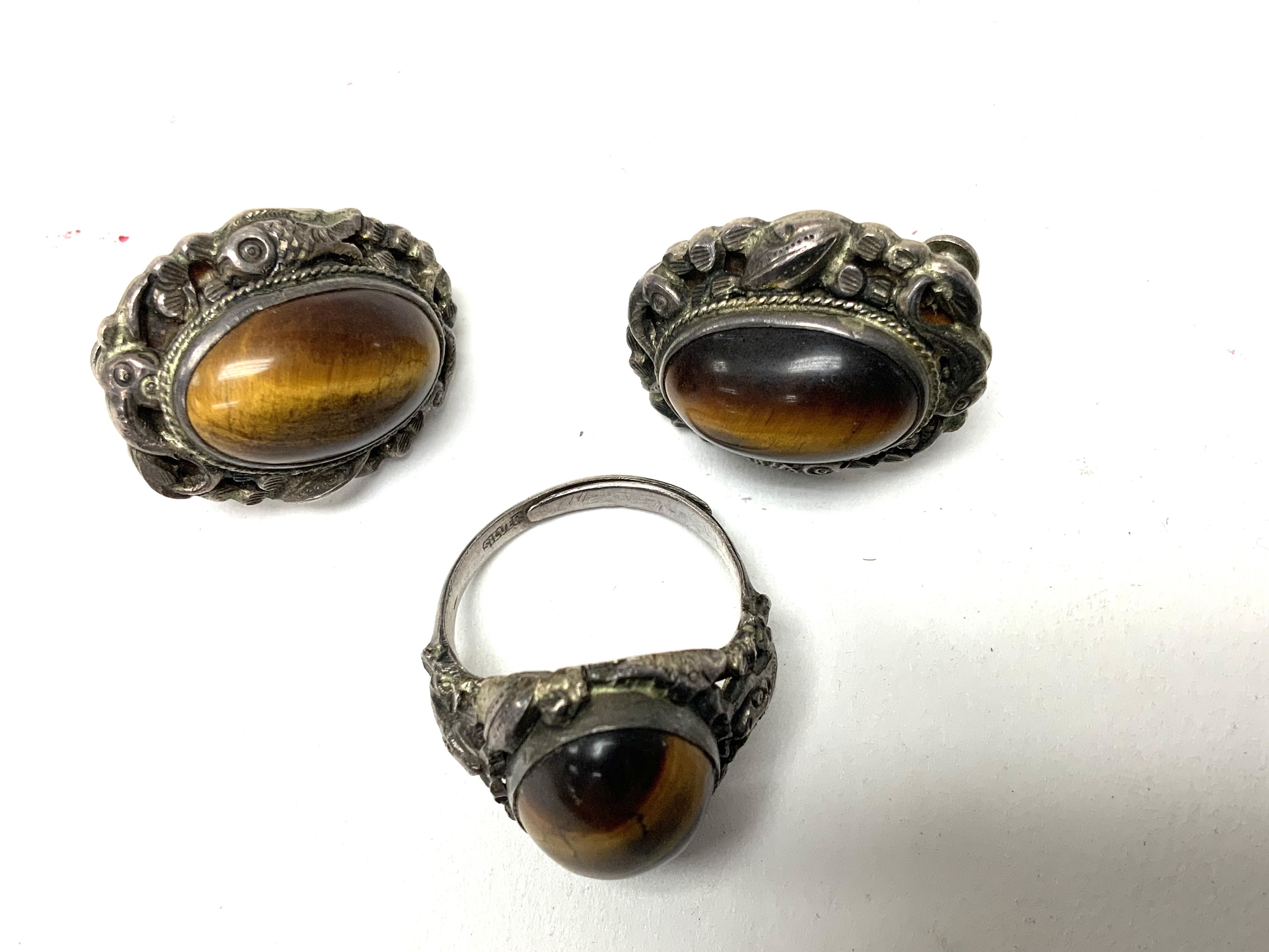 A Chinese silver and cabochons tigers eye ring and
