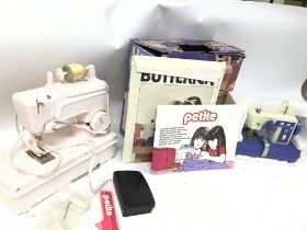 A boxed petite toy sewing machine, universal one