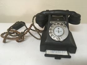 A Vintage black Bakelite telephone.