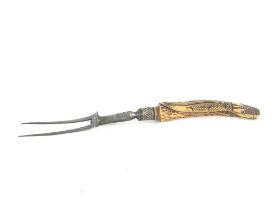 Two pronged carving fork with an engraved crocodil