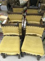 A group of six oak chairs with yellow upholstery d