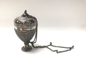 A white metal incense burner with engraved buddhis