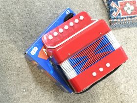 A miniature boxed accordion in working condition