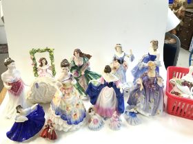 A collection of porcelain Royal Doulton lady figurines and old country rose posies. Figures