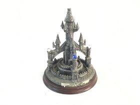 Metal statue of a gothic castle, decorated with je