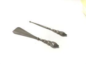 A hallmarked Silver shoe horn and silver button ho