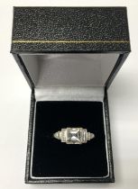 WITHDRAWN - A platinum ring set with baguette diamond shoulders with Ascher cut centre stone,