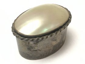A mother of Pearl lidded box set in silver. Postag
