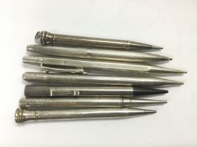 Seven silver propelling pens and pencils. Shipping