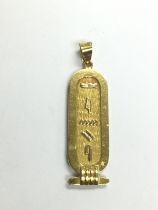 A high grade gold pendant decorated with hieroglyp