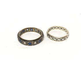 Two eternity rings set with coloured stones.