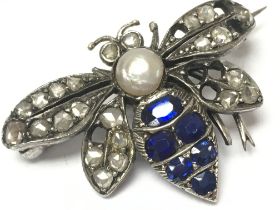 An unmarked white metal bee brooch set with diamon