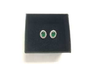 A pair of 18ct white gold, oval emerald and RBC di