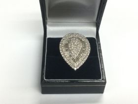 A large 9ct white gold teardrop shaped diamond clu