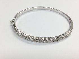A 9ct white gold hinged bangle set with 2.21ct RBC