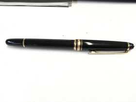 A mont blanc fountain pen with box and paperwork.