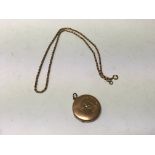 A 9ct gold oval locket with chain set with an old