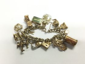 A 9ct gold charm bracelet, approx 55g. Shipping ca