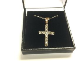 A gold cross set with mixed rose cut diamonds, app